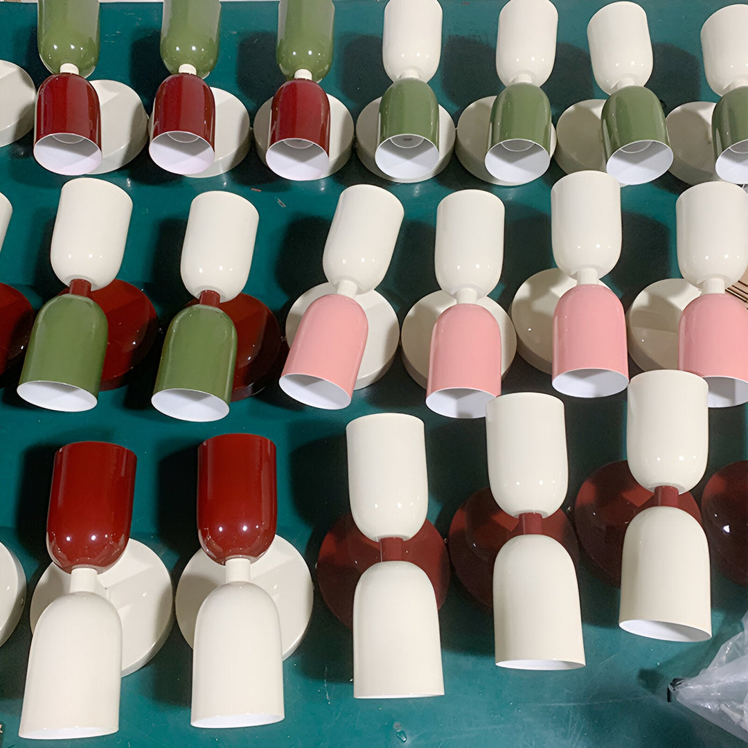 Nordic colourful double head wall light in vibrant colors, painted iron, sleek cylindrical design, casts light up and down.