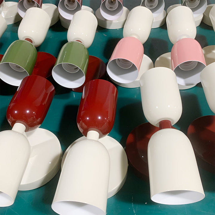 Nordic colourful double head wall light in vibrant colors, painted iron, sleek cylindrical design, casts light up and down.