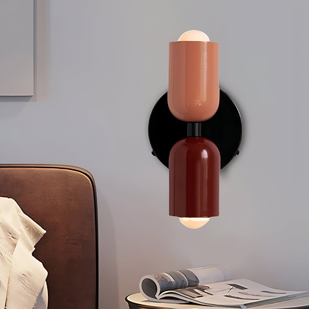 Nordic colourful double head wall light in vibrant colors, painted iron, sleek cylindrical design, casts light up and down.