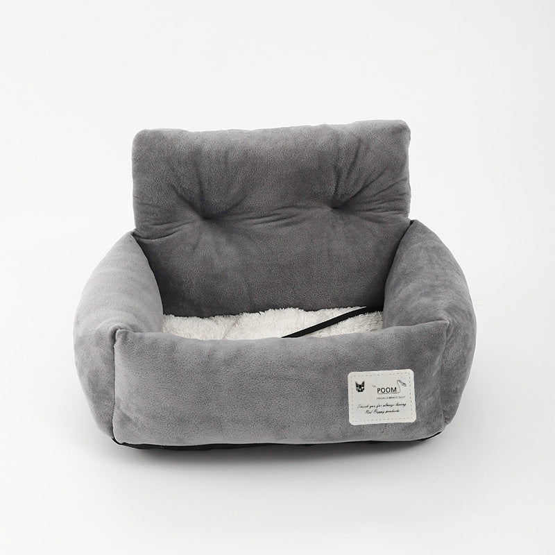 "Soft cushioned dog car seat with safety straps for secure travel, fitting most vehicles, ideal for comfortable pet journeys.