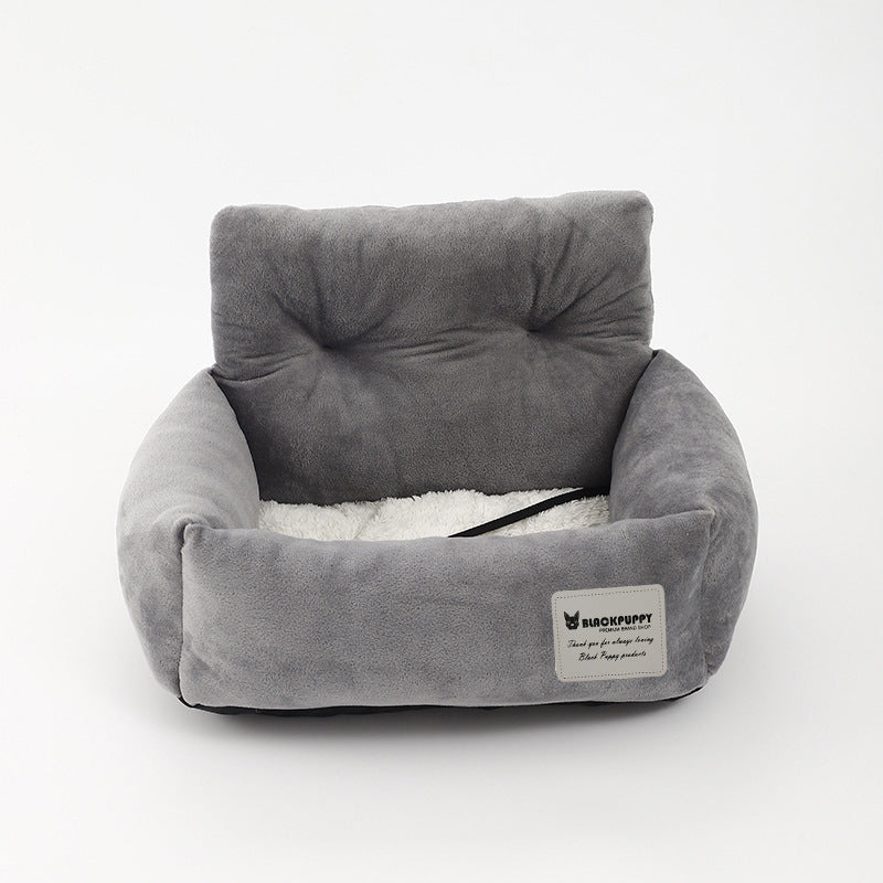 "Soft cushioned dog car seat with safety straps for secure travel, fitting most vehicles, ideal for comfortable pet journeys.