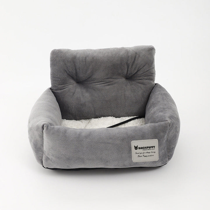 "Soft cushioned dog car seat with safety straps for secure travel, fitting most vehicles, ideal for comfortable pet journeys.