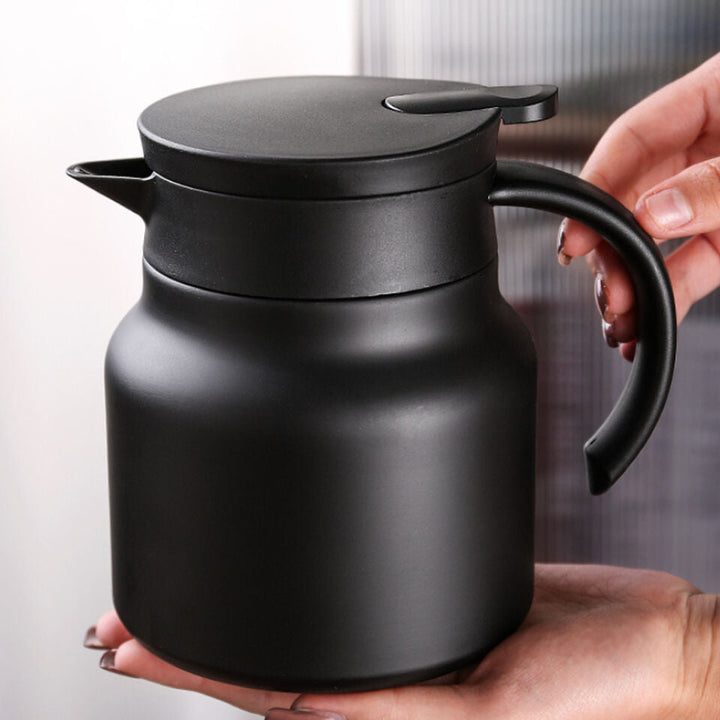 "Stainless steel insulation pot, polished finish, spill-proof jug, V-spout, integrated handle, sleek thermal design"