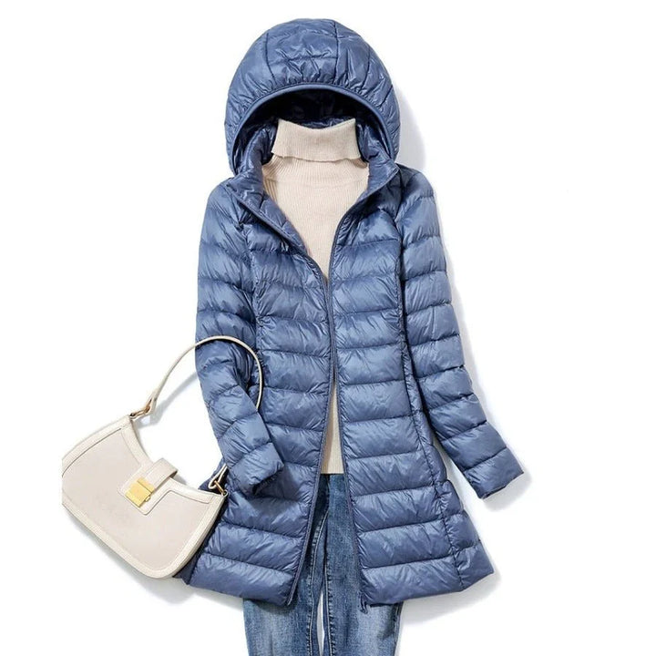 "Stylish women's long hooded puffer jacket with quilted design and extended length for warmth and protection in winter."