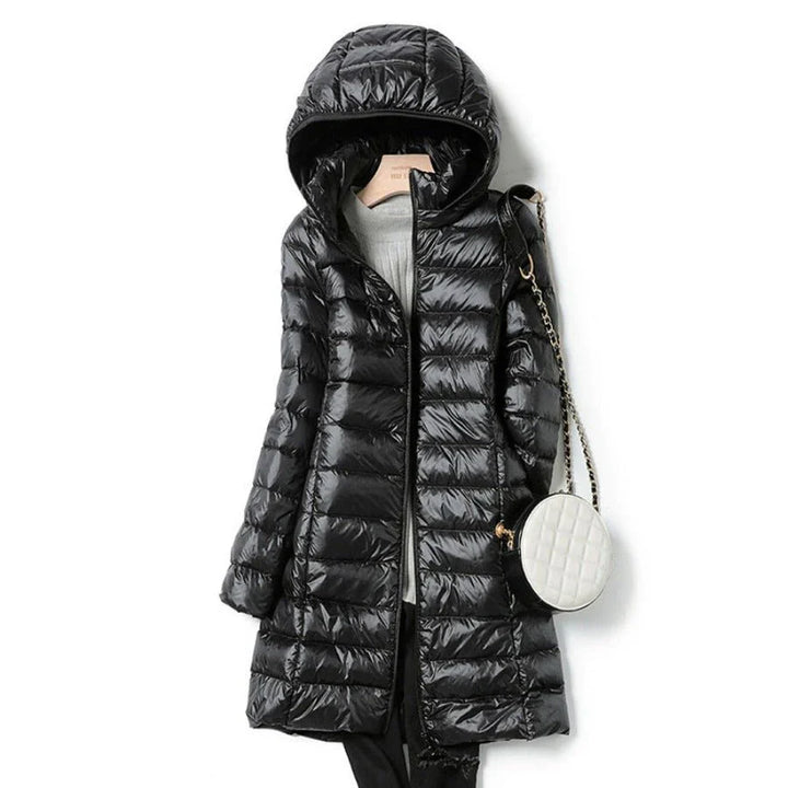 "Stylish women's long hooded puffer jacket with quilted design and extended length for warmth and protection in winter."