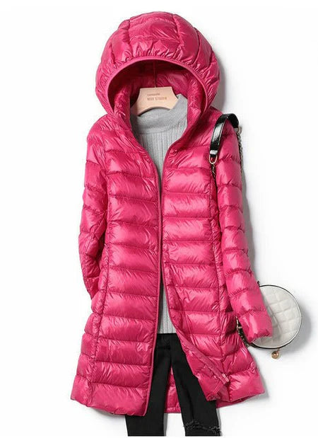 "Stylish women's long hooded puffer jacket with quilted design and extended length for warmth and protection in winter."