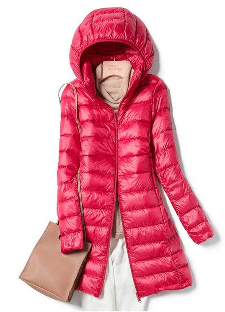 "Stylish women's long hooded puffer jacket with quilted design and extended length for warmth and protection in winter."