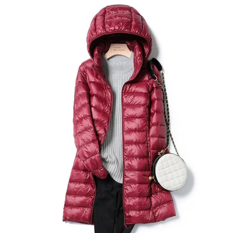 "Stylish women's long hooded puffer jacket with quilted design and extended length for warmth and protection in winter."