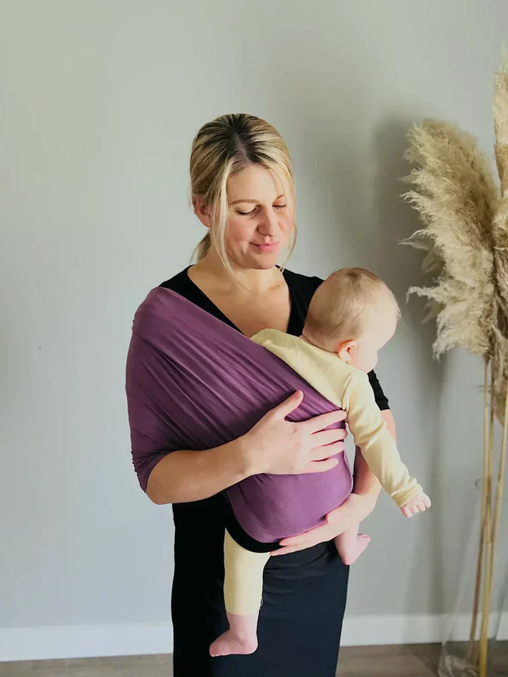 "Unisex ergonomic baby wrap carrier, grey, enveloping baby and parent comfortably for hands-free convenience."