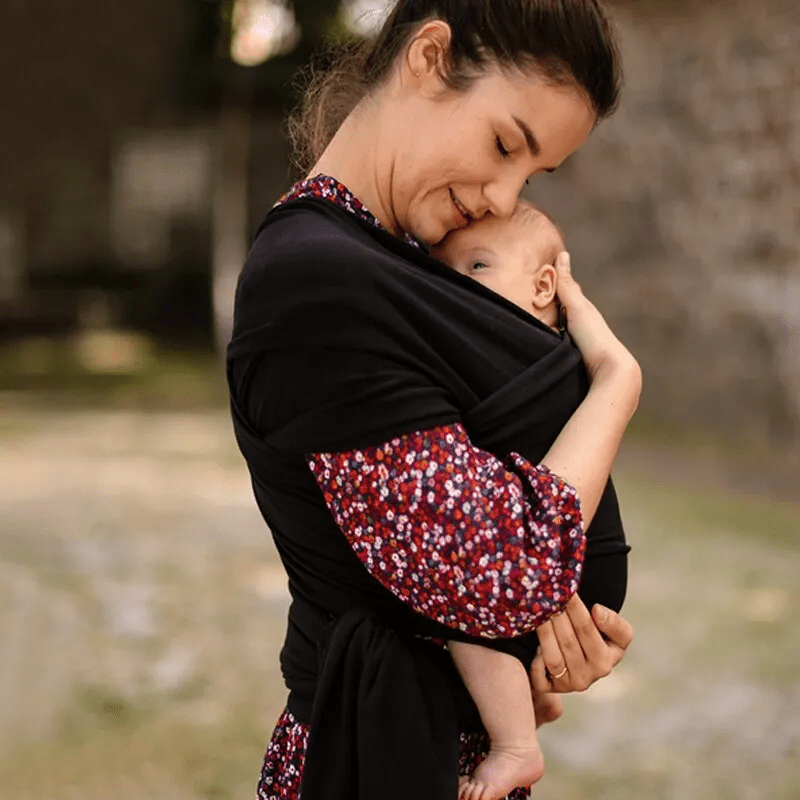 "Unisex ergonomic baby wrap carrier, grey, enveloping baby and parent comfortably for hands-free convenience."