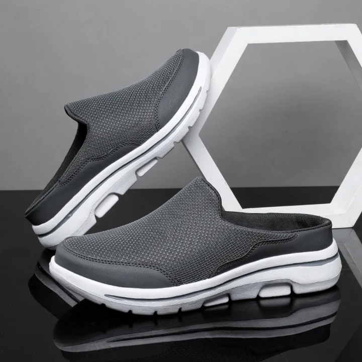 Unisex slip-on sports shoes with breathable mesh, cushioned insole, and sleek design in grey, black, blue, and brown.