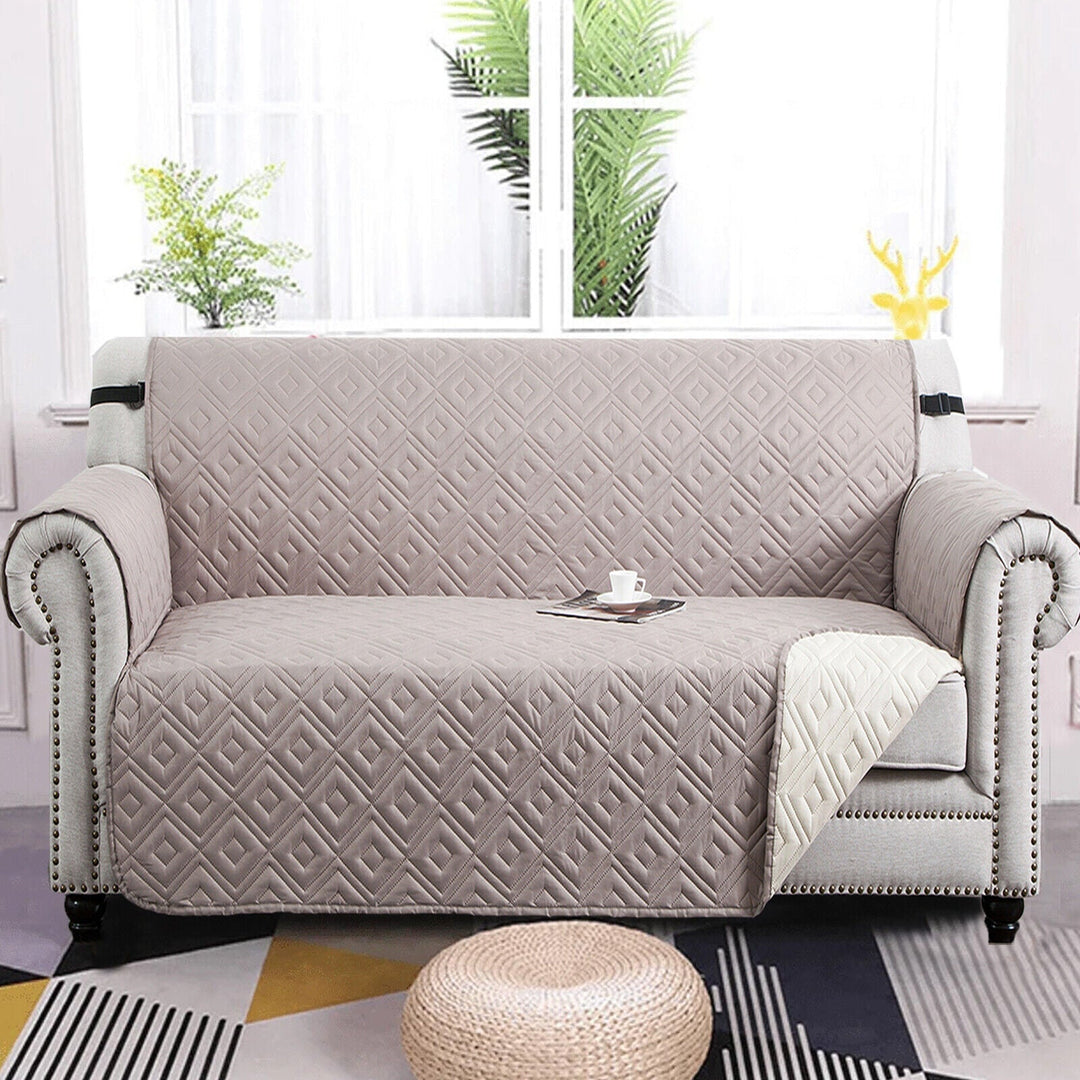 "Water-repellent non-slip reversible sofa cover protecting couch from spills and stains with pet sitting on it"