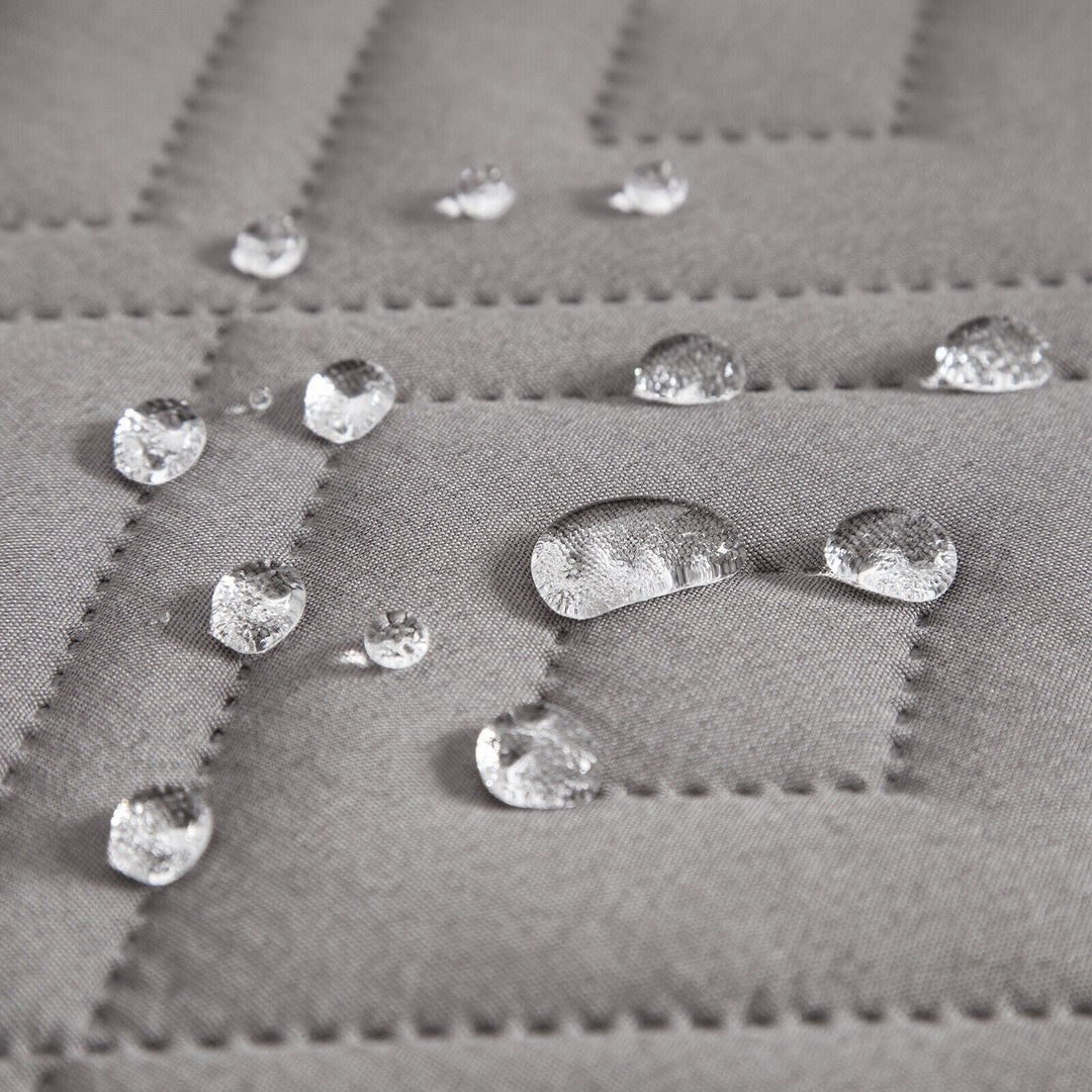 "Water-repellent non-slip reversible sofa cover protecting couch from spills and stains with pet sitting on it"