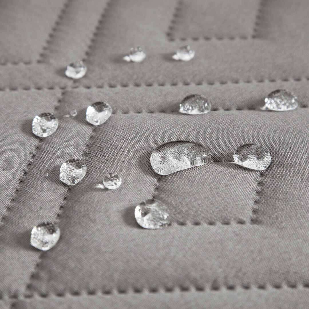 "Water-repellent non-slip reversible sofa cover protecting couch from spills and stains with pet sitting on it"