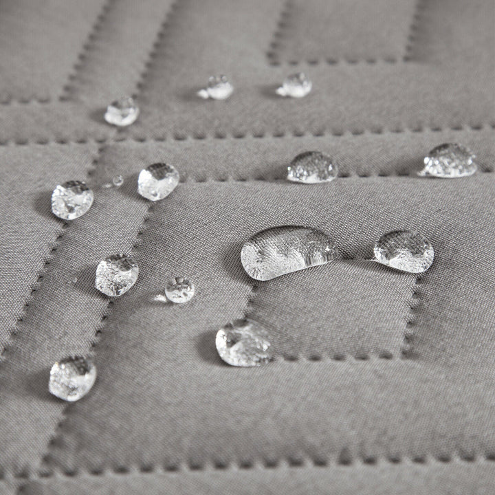 "Water-repellent non-slip reversible sofa cover protecting couch from spills and stains with pet sitting on it"