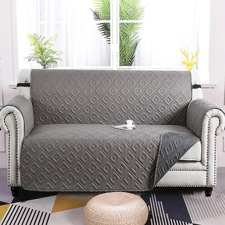 "Water-repellent non-slip reversible sofa cover protecting couch from spills and stains with pet sitting on it"