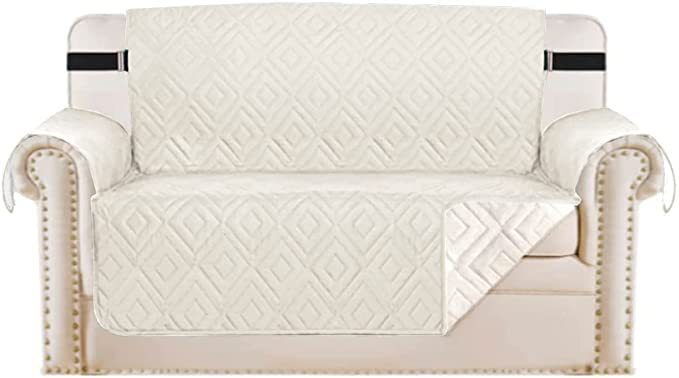 "Water-repellent non-slip reversible sofa cover protecting couch from spills and stains with pet sitting on it"