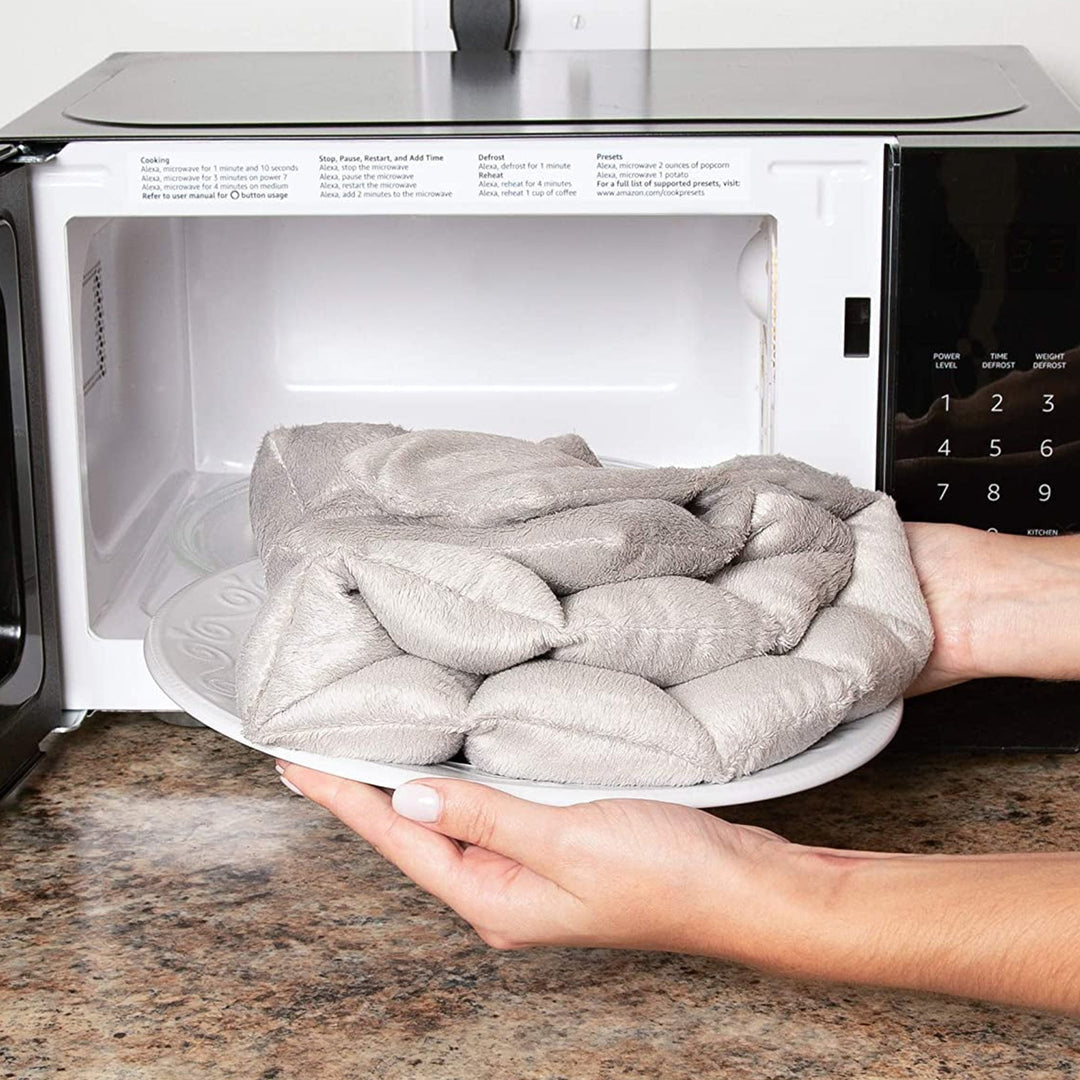 "Weighted Neck & Shoulder Wrap in beige, showing ergonomic design with even distribution for stress relief and relaxation."