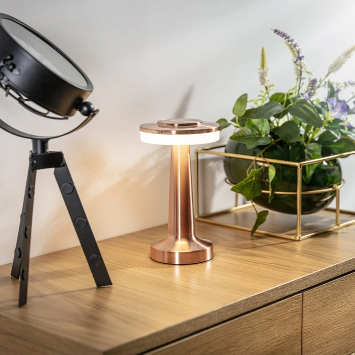 "Wireless retro table lamp with luxurious metallic finish, dimmable LED light, versatile cordless design for any setting."