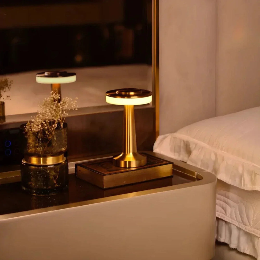 "Wireless retro table lamp with luxurious metallic finish, dimmable LED light, versatile cordless design for any setting."