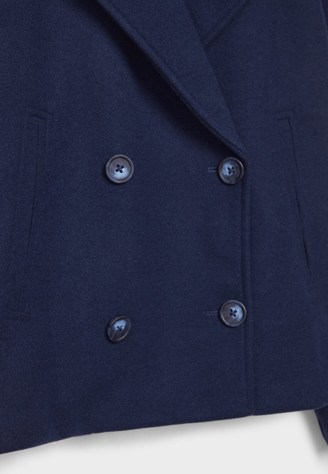 Women's double-breasted cropped jacket, front view featuring sharp lapels, structured design, and chic oversized buttons.
