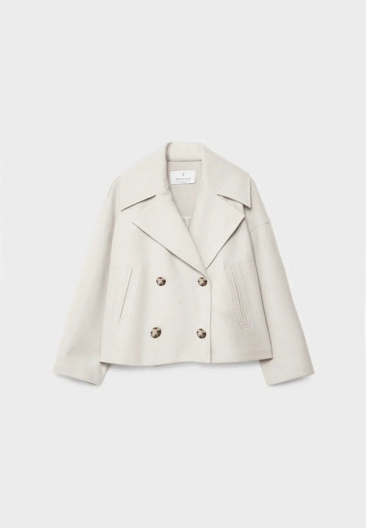 Women's double-breasted cropped jacket, front view featuring sharp lapels, structured design, and chic oversized buttons.