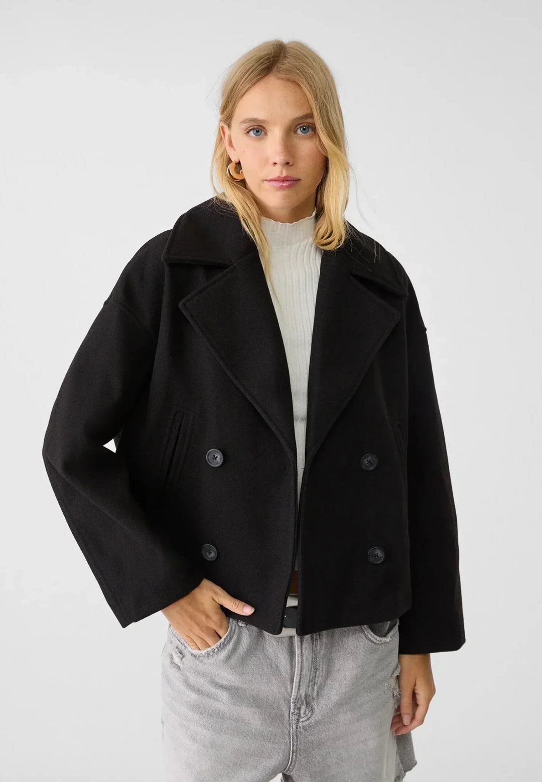 Women's double-breasted cropped jacket, front view featuring sharp lapels, structured design, and chic oversized buttons.
