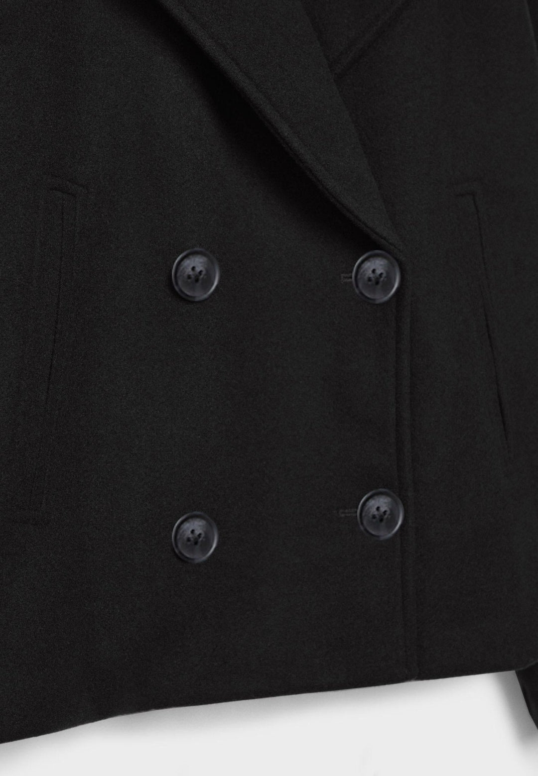 Women's double-breasted cropped jacket, front view featuring sharp lapels, structured design, and chic oversized buttons.