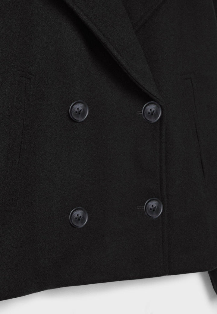 Women's double-breasted cropped jacket, front view featuring sharp lapels, structured design, and chic oversized buttons.