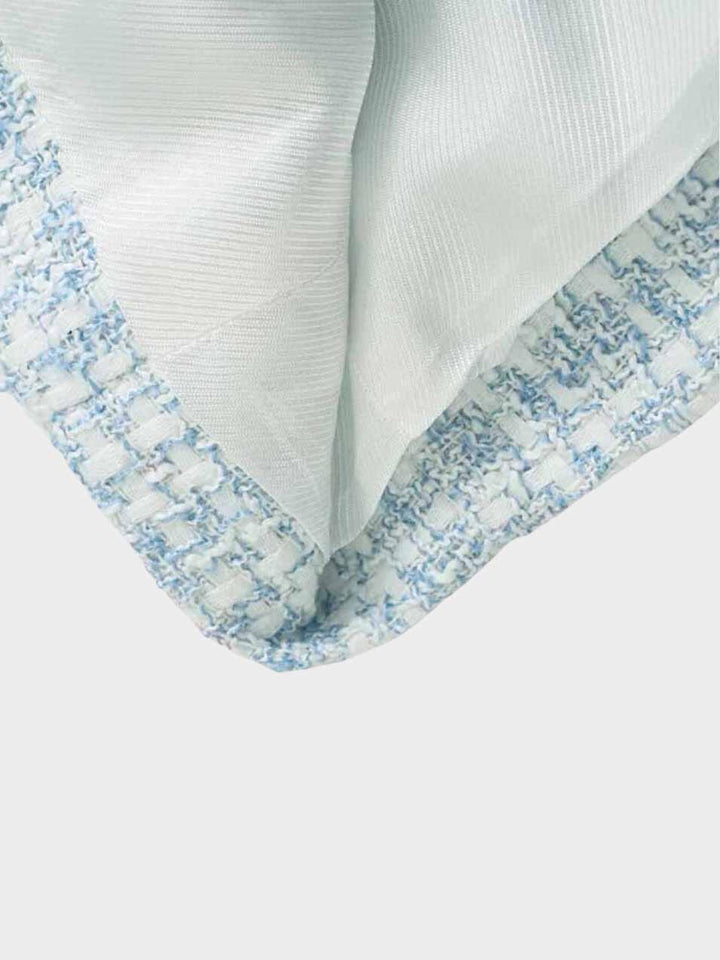 Women's fashionable light blue tweed blazer, front view. Tailored fit, elegant design, classic silhouette for versatile wear.