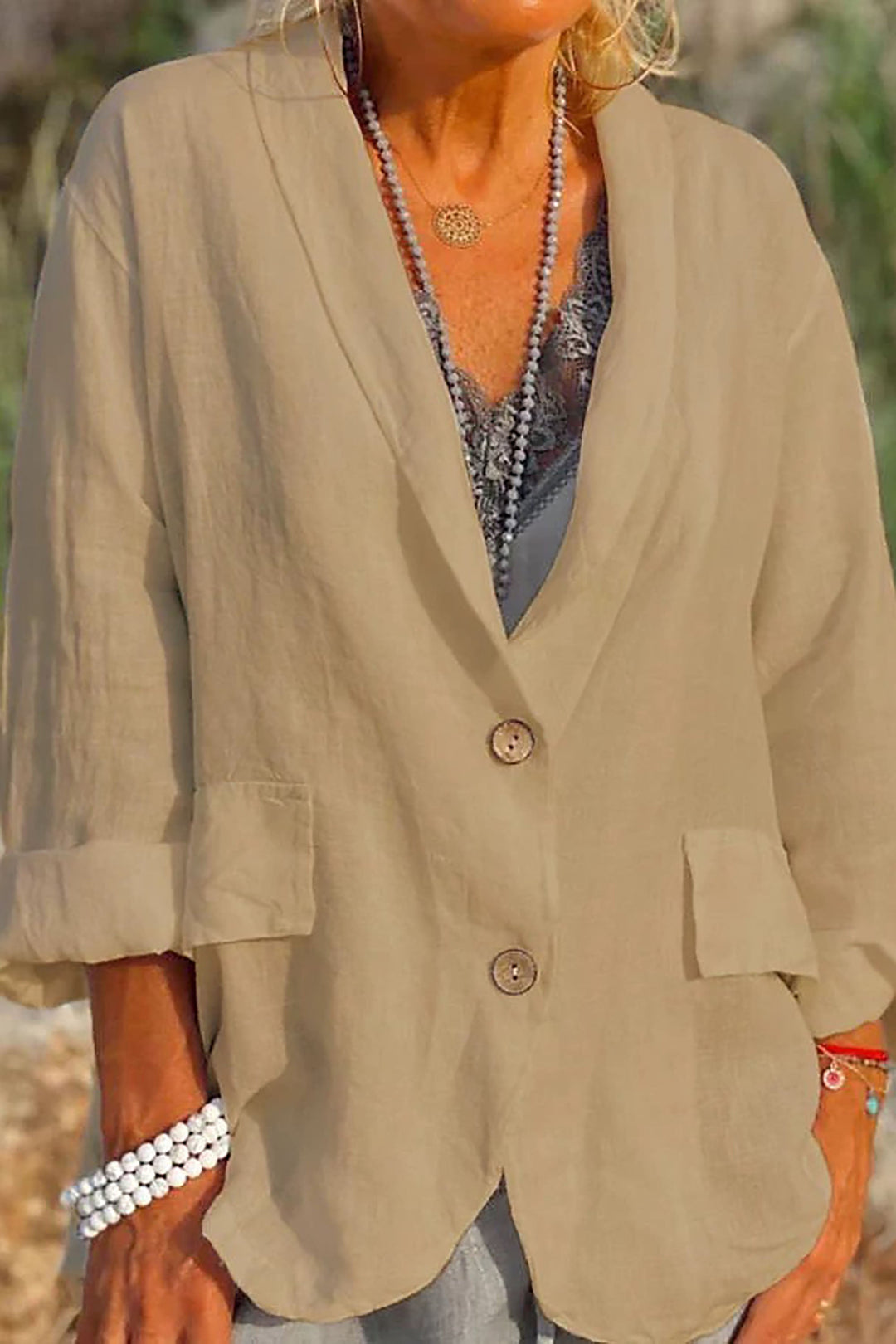 Women's light linen blazer with buttons, V-neck, and long sleeves; shown in white. Perfect for versatile, chic style.