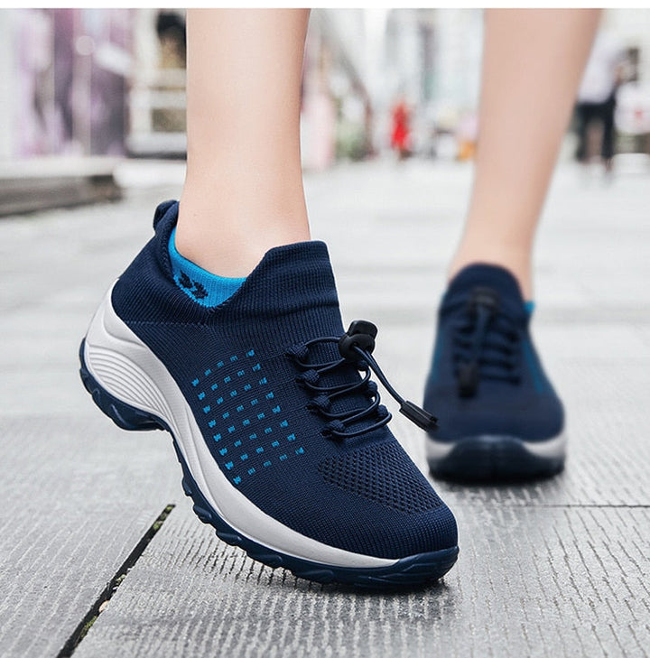 "Women's orthopaedic comfort shoes with contoured footbed, mesh upper in black and purple, providing advanced support."