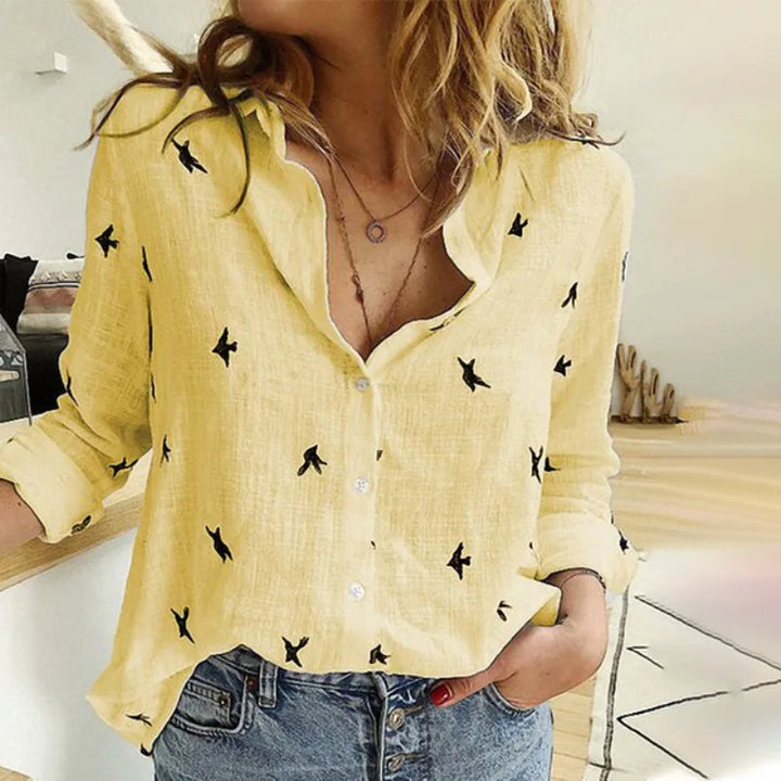 "Women's relaxed bird-print button-up blouse with colorful bird patterns, flowy silhouette, perfect for casual or office wear