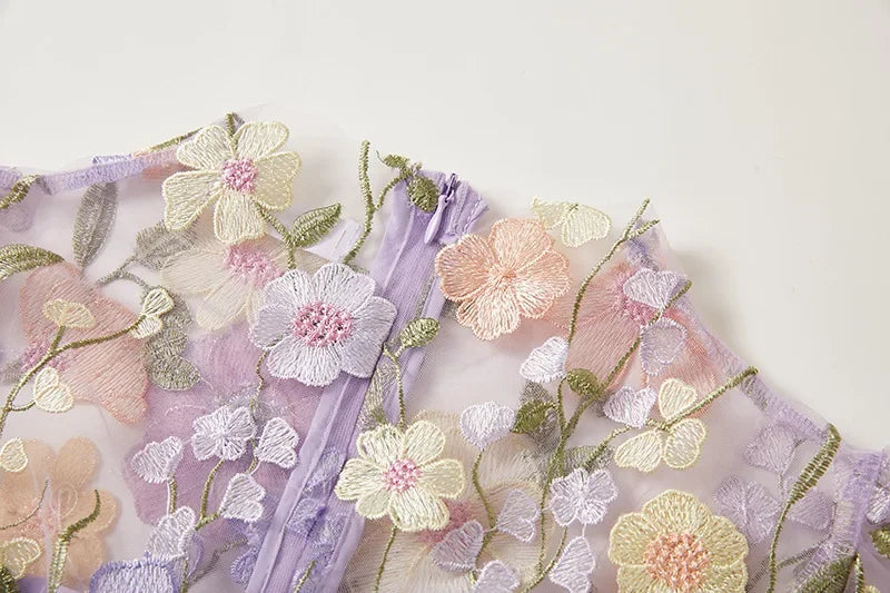 "Women's sheer embroidered maxi dress, elegant and flowing, in various colors; lightweight fabric for special occasions."