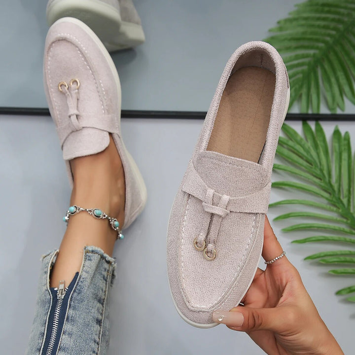 Women's suede finish loafers in white, offering comfort and style. Perfect casual shoes for elegance and ease.