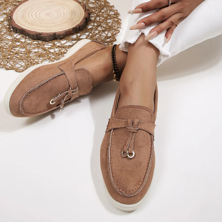 Women's suede finish loafers in white, offering comfort and style. Perfect casual shoes for elegance and ease.