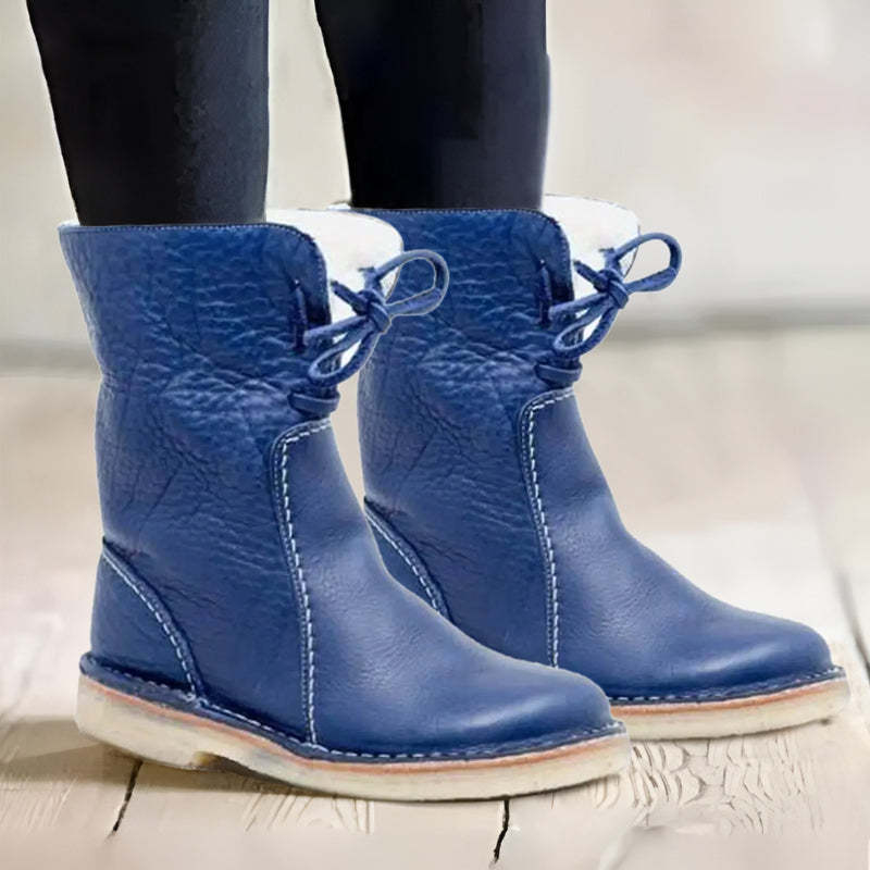 "Women's winter boots, waterproof leather with wool lining, offering style and warmth for cold weather conditions."