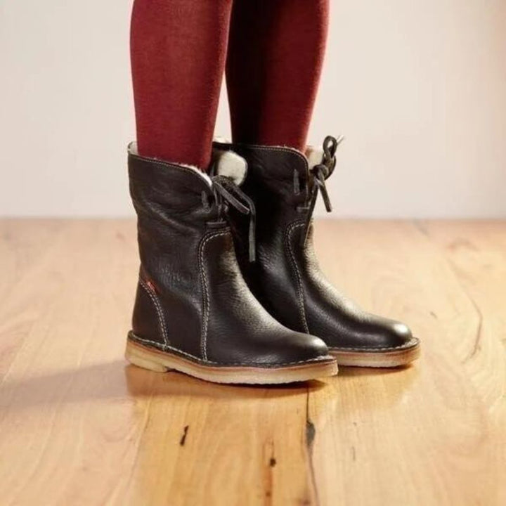 "Women's winter boots, waterproof leather with wool lining, offering style and warmth for cold weather conditions."