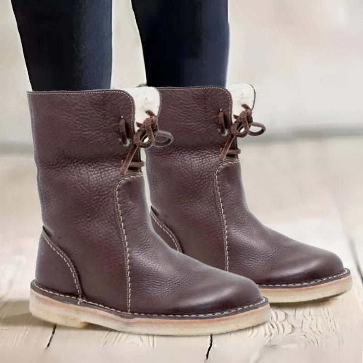 "Women's winter boots, waterproof leather with wool lining, offering style and warmth for cold weather conditions."