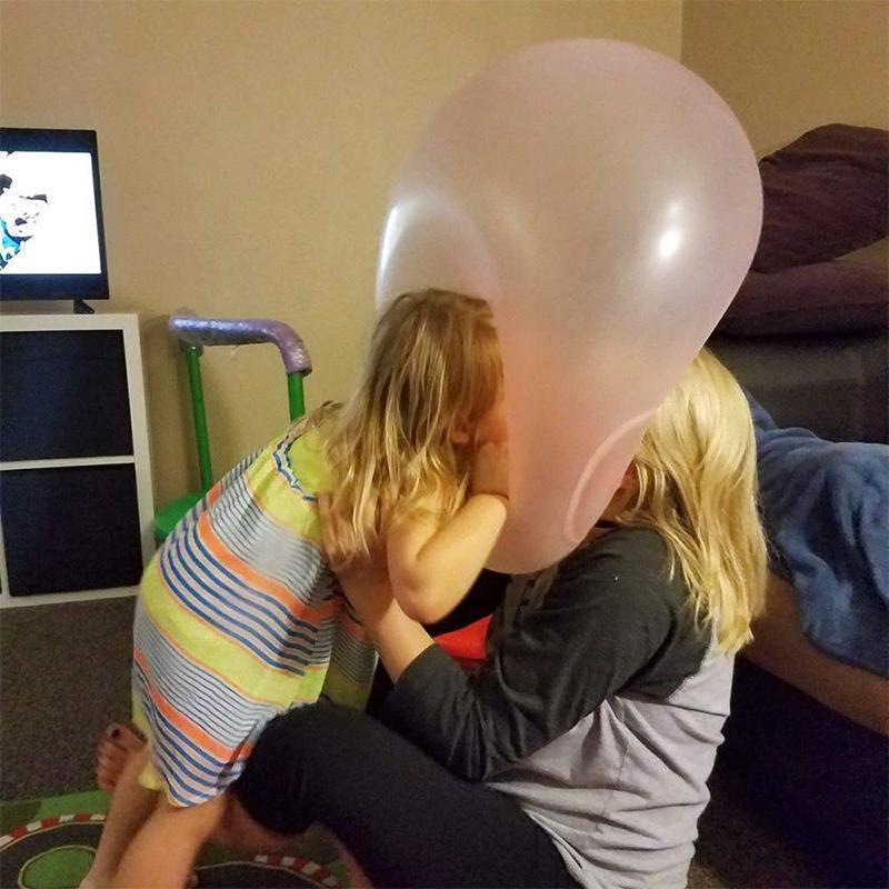 A family enjoying a picnic with a giant inflatable water bubble ball as a fun centerpiece.
