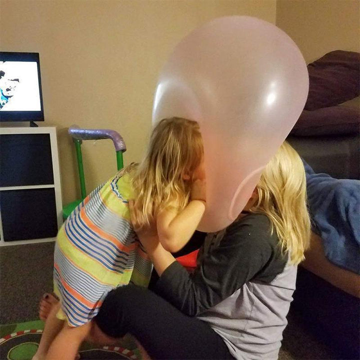 A family enjoying a picnic with a giant inflatable water bubble ball as a fun centerpiece.