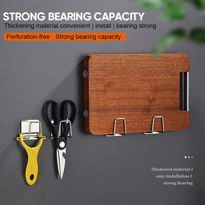 Adhesive stainless steel sponge holder mounted on a kitchen sink wall, organizing cleaning supplies