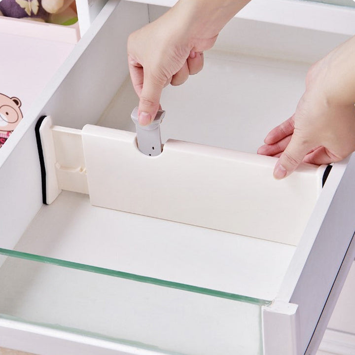Close-up of interlocking adjustable drawer organizer divider in a kitchen drawer, efficient storage