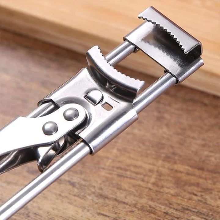 Manual kitchen tool: adjustable stainless steel jar opener, shown close-up on its gripping mechanism.