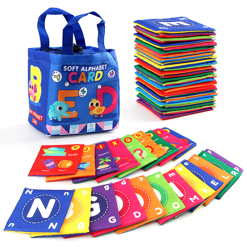 Baby hand turning a page of a crinkly Soft Cloth Learning Book, educational infant toy