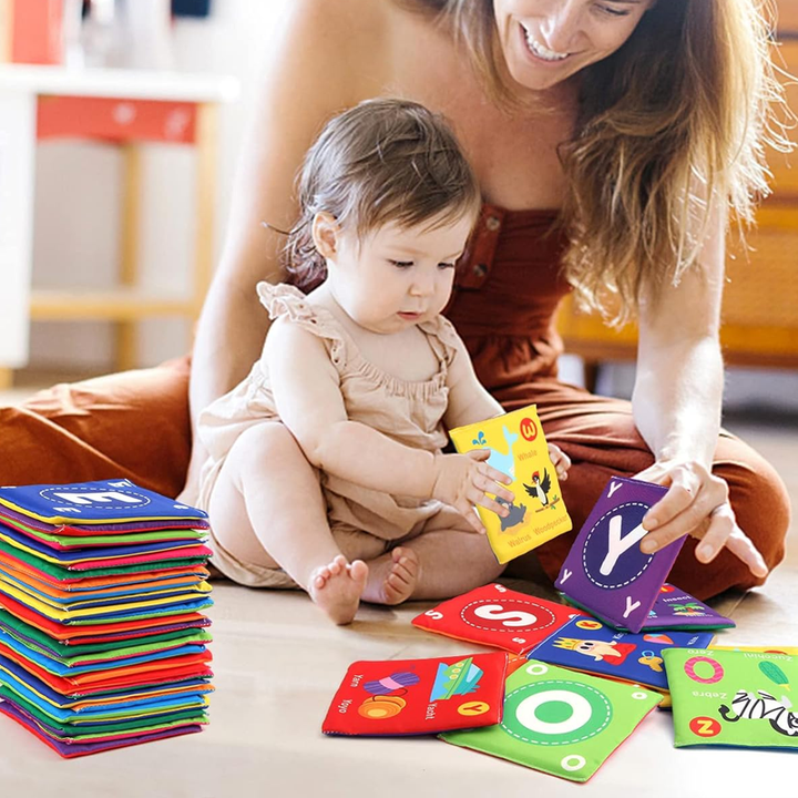 Toddler holding a colorful soft cloth book, engaging in early education activities