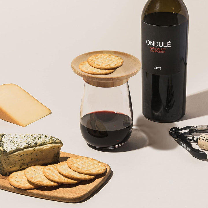 Close-up of bamboo wine glass charcuterie topper with a unique, practical design