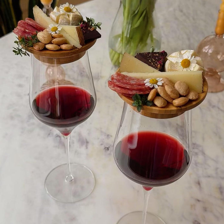 Portable bamboo charcuterie board, designed to sit atop a wine glass for hands-free enjoyment
