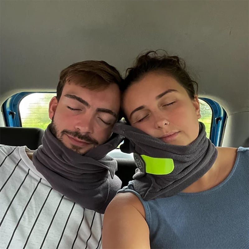 Coral red ergonomic travel neck pillow, highlighting its plush material and ergonomic design for comfort.