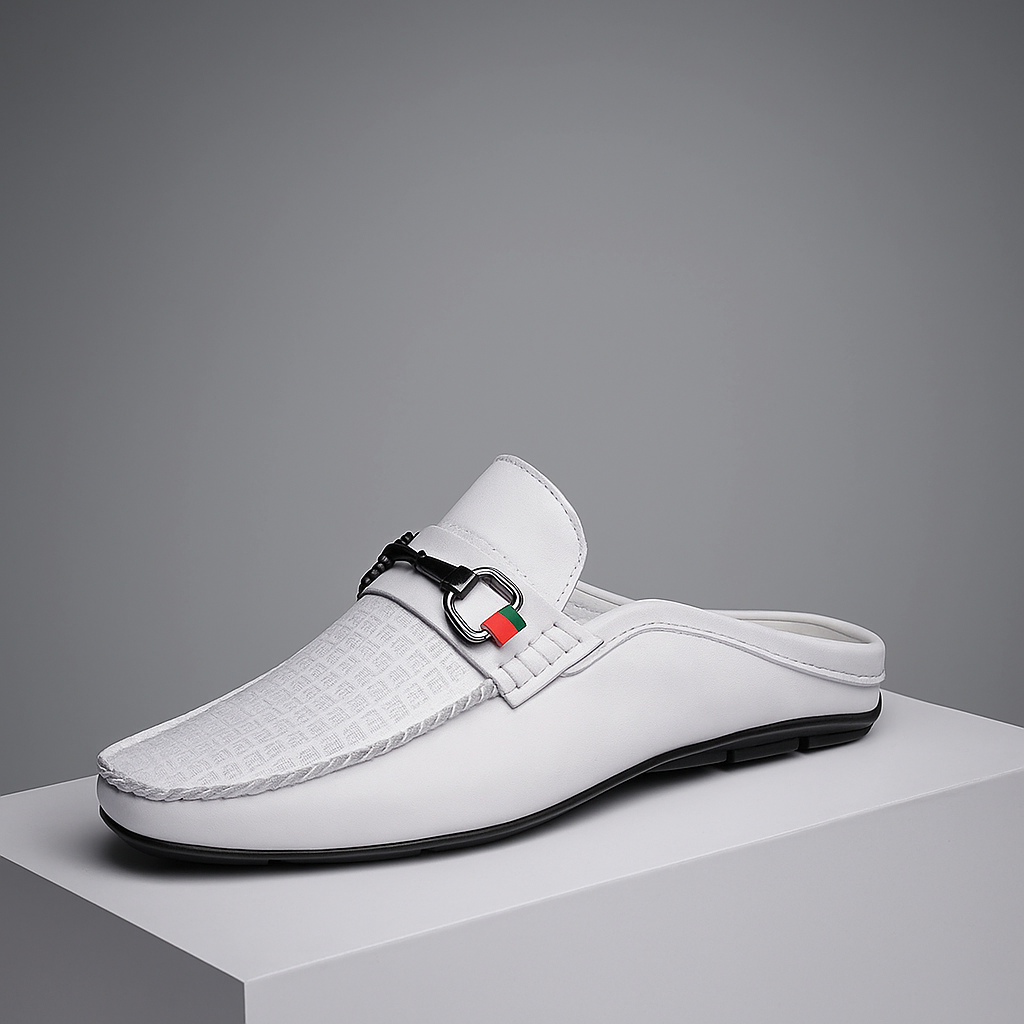 Black leather slip-on mules for women with elegant metal bit detail, perfect for casual or dressy wear.